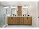 Bright bathroom featuring a double vanity with granite countertops and a modern glass shower enclosure at 935 Eden Isle Ne Dr, St Petersburg, FL 33704