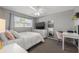 Cozy bedroom featuring a ceiling fan, dresser with television, and desk with chair at 935 Eden Isle Ne Dr, St Petersburg, FL 33704