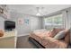 Neutral bedroom with a ceiling fan, window, and double closet at 935 Eden Isle Ne Dr, St Petersburg, FL 33704