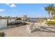 The backyard includes a private dock, a boat lift, and comfortable outdoor seating at 935 Eden Isle Ne Dr, St Petersburg, FL 33704