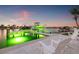 Waterfront property featuring a private boat dock, boat lift, and seating to enjoy the waterfront at 935 Eden Isle Ne Dr, St Petersburg, FL 33704