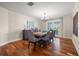 Elegant dining room featuring a large dining table, hardwood floors, and a chandelier at 935 Eden Isle Ne Dr, St Petersburg, FL 33704