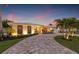 Charming single-story home with a circular driveway, manicured landscaping, and inviting entrance at 935 Eden Isle Ne Dr, St Petersburg, FL 33704