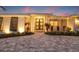 Elegant home exterior showcasing a beautifully landscaped front yard and inviting entrance with double doors at 935 Eden Isle Ne Dr, St Petersburg, FL 33704