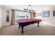 Entertaining game room featuring a pool table and bay window with waterfront views at 935 Eden Isle Ne Dr, St Petersburg, FL 33704