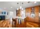 Bright kitchen with wooden cabinets, granite countertop island, pendant lights and a bar stool at 935 Eden Isle Ne Dr, St Petersburg, FL 33704