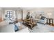 Bright and airy living room with comfortable seating, stylish decor, and seamless flow to other living spaces at 935 Eden Isle Ne Dr, St Petersburg, FL 33704