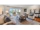 Bright living room featuring a comfortable sofa, chairs, and sliding glass doors leading to the outdoor area at 935 Eden Isle Ne Dr, St Petersburg, FL 33704