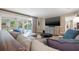 Bright living room with a comfortable sectional sofa, large TV, and sliding glass doors leading to the pool at 935 Eden Isle Ne Dr, St Petersburg, FL 33704