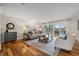 Spacious living room features hardwood floors, stylish decor, and sliding glass doors leading to the outdoor patio at 935 Eden Isle Ne Dr, St Petersburg, FL 33704