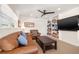 Cozy living room with leather furniture, a dark wood coffee table, and built-in shelving at 935 Eden Isle Ne Dr, St Petersburg, FL 33704