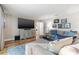 Comfortable living room featuring a large TV, sofa, and stylish decor, creating a cozy atmosphere at 935 Eden Isle Ne Dr, St Petersburg, FL 33704