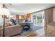 Spacious living room with hardwood floors, large sectional sofa, and sliding glass doors to the patio at 935 Eden Isle Ne Dr, St Petersburg, FL 33704