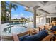 Inviting pool and spa area with lush landscaping, perfect for relaxation and outdoor entertainment by the water at 935 Eden Isle Ne Dr, St Petersburg, FL 33704