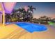 Beautiful pool area with lush tropical landscaping offering privacy and a resort-like experience at 935 Eden Isle Ne Dr, St Petersburg, FL 33704