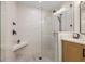 Contemporary shower with neutral tile, a frameless glass enclosure, and matte black fixtures at 935 Eden Isle Ne Dr, St Petersburg, FL 33704
