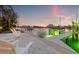 Beautiful waterfront patio features white Adirondack chairs and a boat lift with underwater lights at 935 Eden Isle Ne Dr, St Petersburg, FL 33704