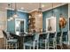 Stylish bar area with a modern design featuring pendant lights and a striking black countertop at 9396 Minnow Ray Dr, Land O Lakes, FL 34638