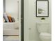 A pristine white toilet sits adjacent to an open doorway that peeks into a neutrally decorated bedroom at 9396 Minnow Ray Dr, Land O Lakes, FL 34638
