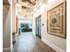 Hallway with plank floors, interior art, and hanging lights leads to front desk reception area at 9396 Minnow Ray Dr, Land O Lakes, FL 34638