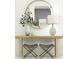 Chic hallway with a round mirror, modern console table, and stylish accessories for a welcoming entry at 9396 Minnow Ray Dr, Land O Lakes, FL 34638