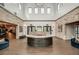 Inviting lobby with wood flooring, stone accent walls, soaring ceiling, and comfortable blue sofas at 9396 Minnow Ray Dr, Land O Lakes, FL 34638