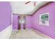 Bedroom with purple walls, carpeted flooring, ceiling fan and a window with curtains at 10130 Burton St, New Port Richey, FL 34654