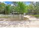 Charming single-story home featuring a white picket fence, attached garage, and lush green trees at 10130 Burton St, New Port Richey, FL 34654