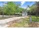 Charming two-story home featuring a white picket fence, attached garage, and lush green trees at 10130 Burton St, New Port Richey, FL 34654
