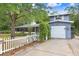 Charming home featuring a blue exterior, attached garage, and a quaint white picket fence at 10130 Burton St, New Port Richey, FL 34654
