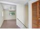 Hallway looking into a living room with tan carpet and a ceiling fan at 10130 Burton St, New Port Richey, FL 34654