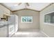Bright eat-in kitchen with white appliances and tile flooring at 10130 Burton St, New Port Richey, FL 34654