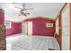 Bright living room featuring tile floors, floral wallpaper and doors to other rooms in the home at 10130 Burton St, New Port Richey, FL 34654
