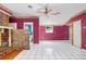 Spacious living room featuring white tile floors, brick fireplace, and great natural light at 10130 Burton St, New Port Richey, FL 34654
