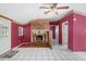 The living room features a brick fireplace, white tile floors and a doorway to another room at 10130 Burton St, New Port Richey, FL 34654
