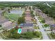 An aerial view showing the house, neighborhood and a pond with fountain at 10223 Charleston Corner Rd, Tampa, FL 33635