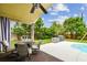 Charming covered patio with fan overlooking the manicured backyard, ideal for outdoor enjoyment at 10223 Charleston Corner Rd, Tampa, FL 33635