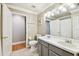 Bathroom with double sinks, large mirror, and doorway access to other rooms at 10223 Charleston Corner Rd, Tampa, FL 33635