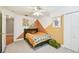Fun bedroom featuring patterned walls, a full bed with olive green accents and carpeted floors at 10223 Charleston Corner Rd, Tampa, FL 33635