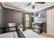 Cozy Bedroom with grey walls, window with olive curtains, a crib, and changing table at 10223 Charleston Corner Rd, Tampa, FL 33635