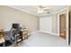 Bedroom with double doors, a ceiling fan, and carpeted floors offers comfortable living space at 10223 Charleston Corner Rd, Tampa, FL 33635