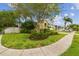 Attractive home with lush landscaping, and a large shade tree on a well maintained lawn at 10223 Charleston Corner Rd, Tampa, FL 33635