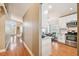 Hallway view of open floor plan of the kitchen with stainless steel appliances and an eat in breakfast nook at 10223 Charleston Corner Rd, Tampa, FL 33635