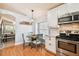 Kitchen with breakfast nook, white cabinets, stainless steel appliances, and marble countertops at 10223 Charleston Corner Rd, Tampa, FL 33635