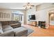 Living room with vaulted ceilings, view to backyard, hardwood floors, and ceiling fan at 10223 Charleston Corner Rd, Tampa, FL 33635