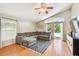 Bright living room with vaulted ceilings, hardwood floors and view to backyard pool at 10223 Charleston Corner Rd, Tampa, FL 33635