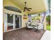 Covered patio features a ceiling fan and comfortable seating, perfect for outdoor entertaining at 10223 Charleston Corner Rd, Tampa, FL 33635
