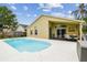 Inviting backyard pool with a covered patio and outdoor dining area, perfect for relaxation at 10223 Charleston Corner Rd, Tampa, FL 33635
