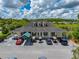 The Tampa Bay Activities Center has a parking area for cars and golf carts with a covered porch in this aerial view at 10324 Chatuge Dr, San Antonio, FL 33576