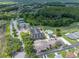 Aerial view of clubhouse, pool, tennis courts, and neighborhood at 10324 Chatuge Dr, San Antonio, FL 33576